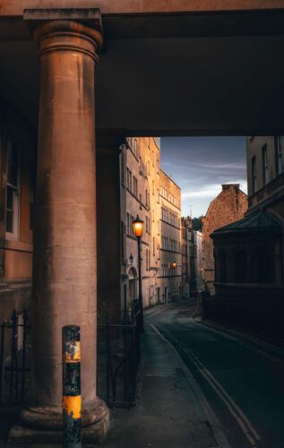 2 Unforgettable Murder Mystery Settings: Cornwall and Bath 2 Narrow historic street in Bath at dusk